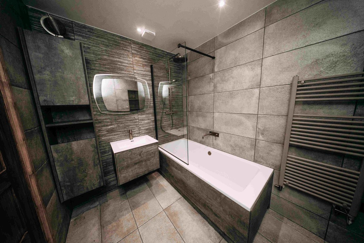 Vanity and bath, wide angle, concrete and bronze