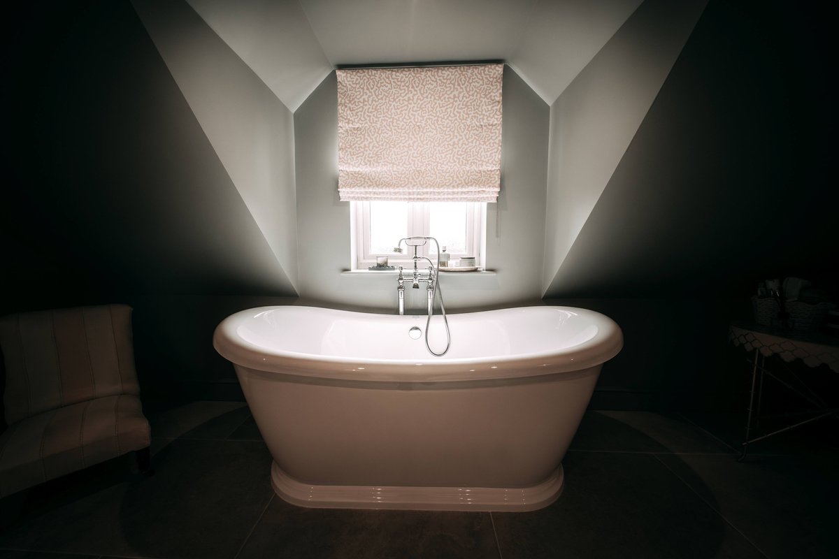 Freestanding slipper bath by a window