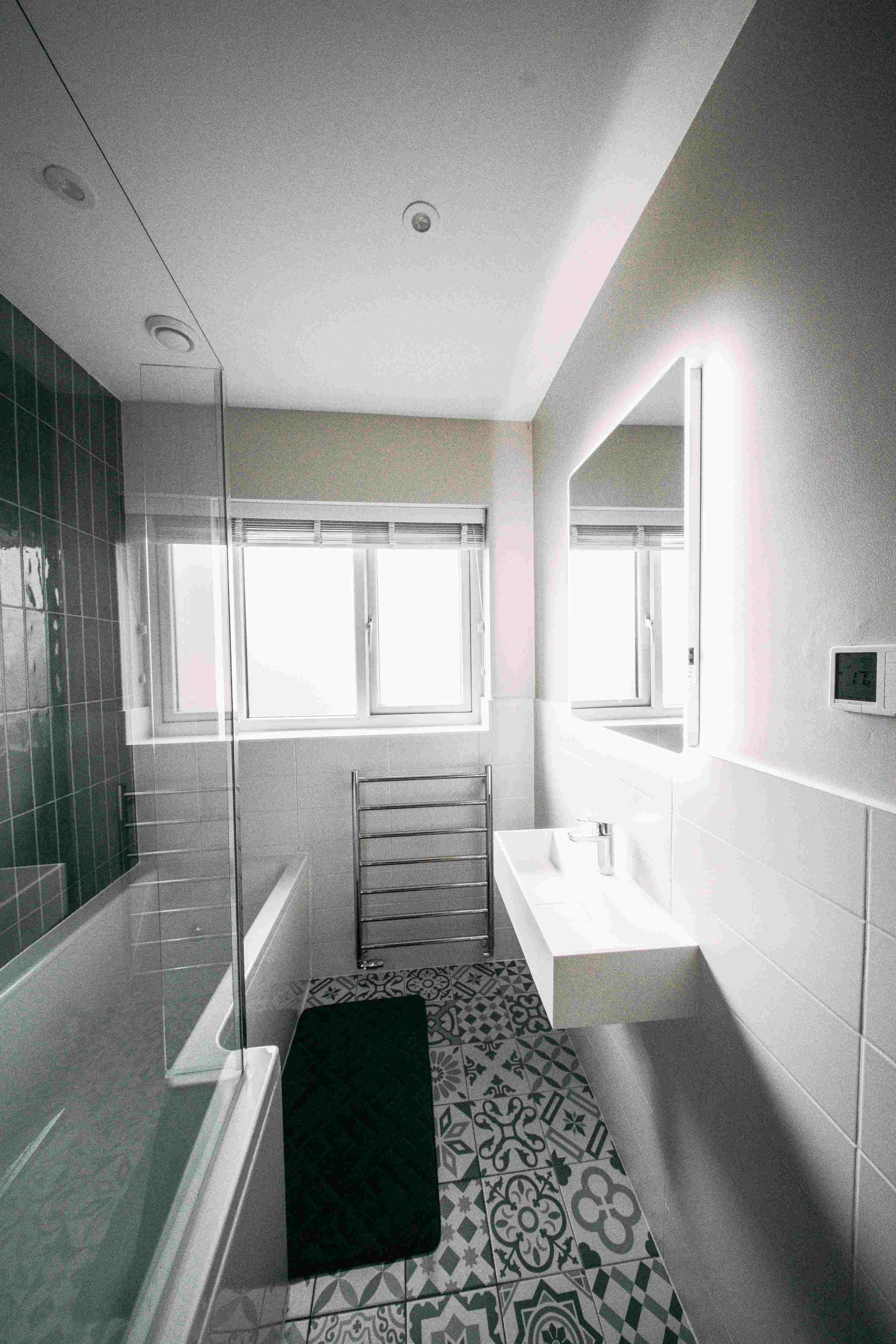 Monochrome bathroom in daylight with encaustic floor
