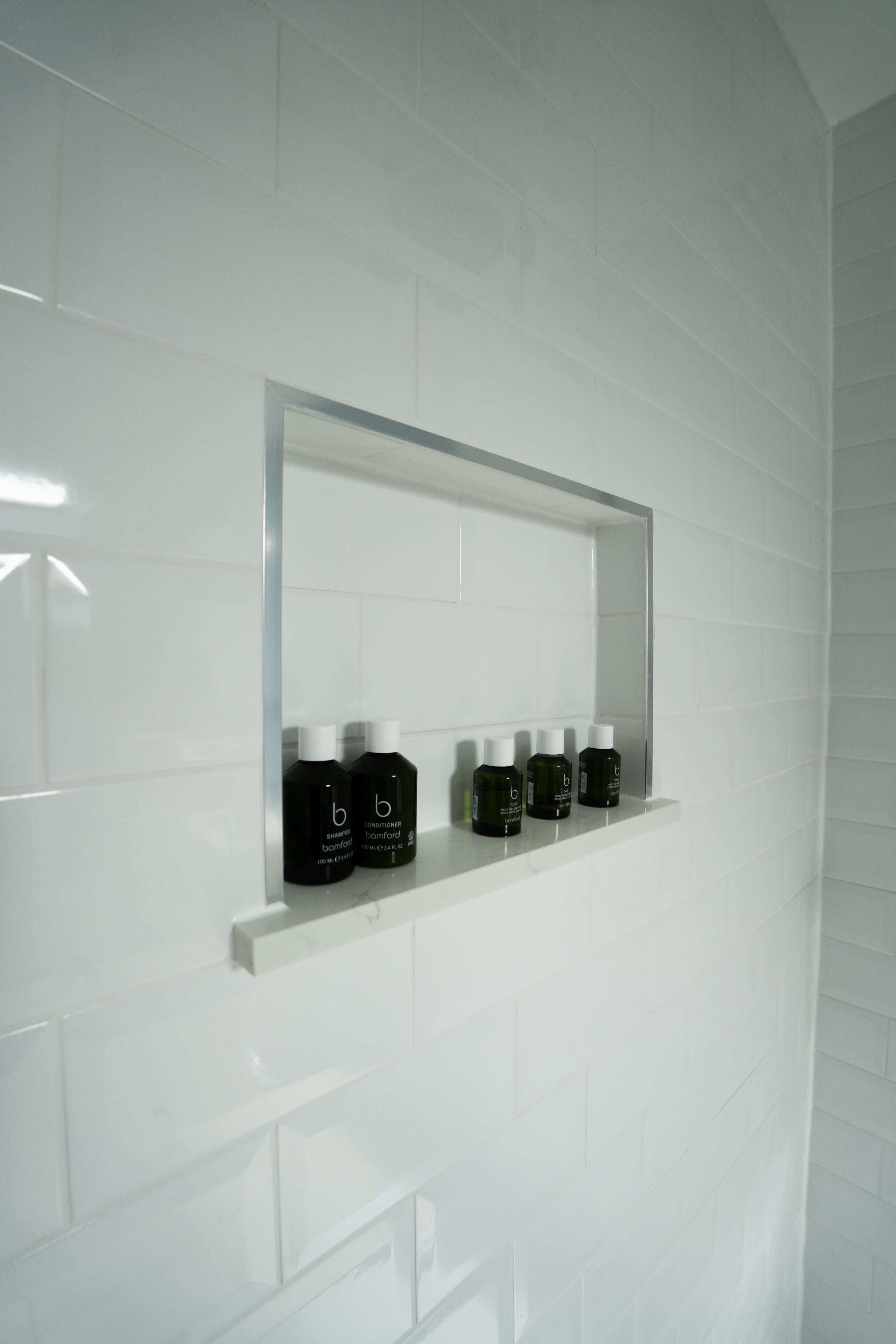 Recessed shower niche with stainless trim