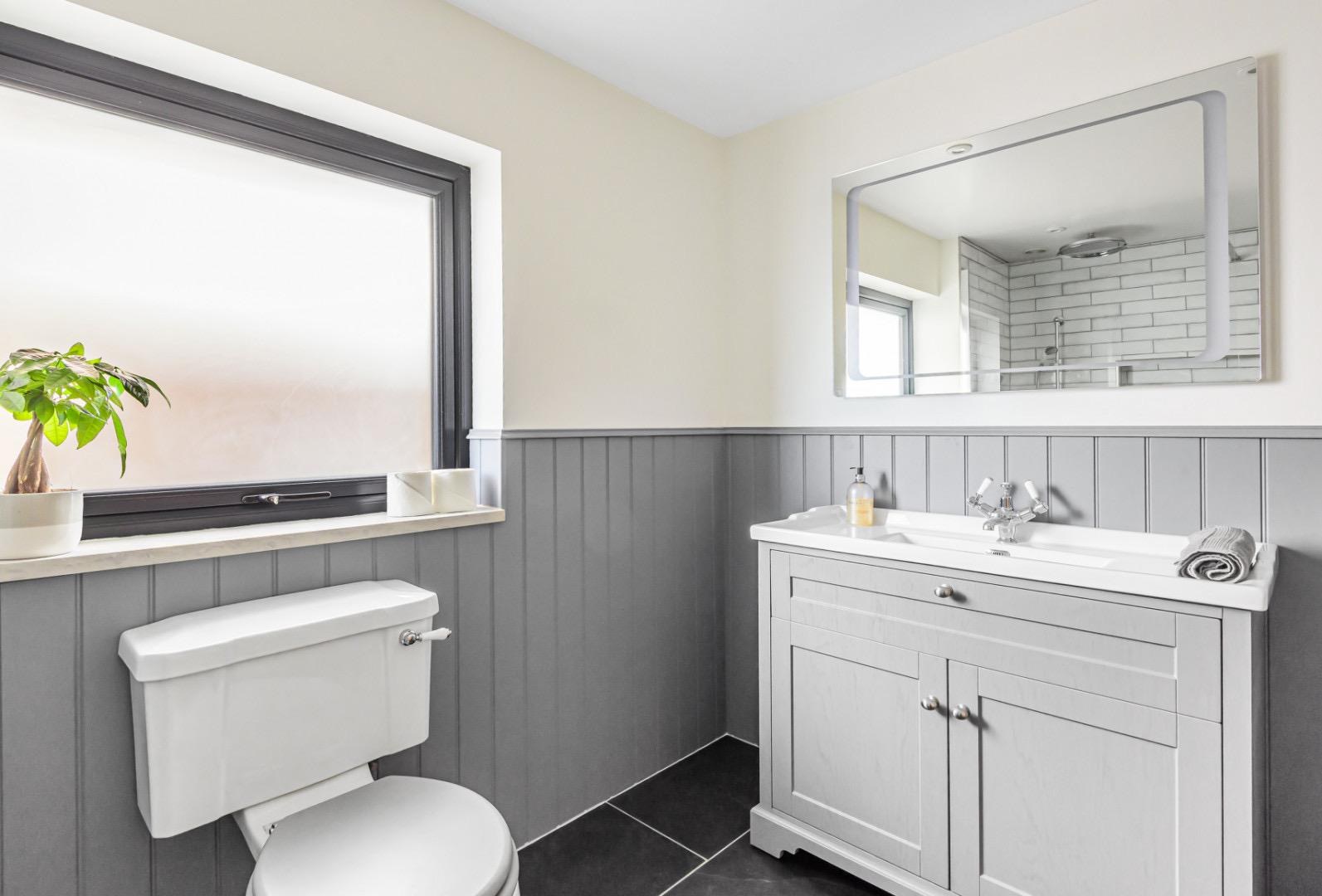A soft grey family bathroom completed by Stonewell